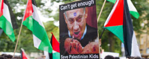 A poster in 2014 depicting PM Netanyahu as a child murderer in front of the Israeli embassy in Berlin. (Photo: Anti Defamation League)