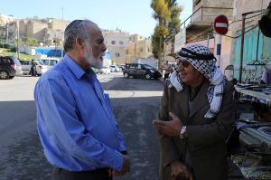A Palestinian and an Israeli seen talking  in Hebron, on December 10, 2014. (Photo: Gershon Elinson/Flash90)