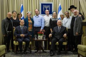 Families of three boys with President Rivlin (sitting, right) and Jerusalem Mayor Barkat (left). Standing (2L) is Rabbi Y.D. Grossman, a major unifying force across the social spectrum. (Photo: Hadas Parush)