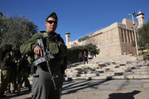 An Israeli soldier stands guard outside the Cave of the Patriarchs in Hebron. (Nati Shohat/ Flash90)