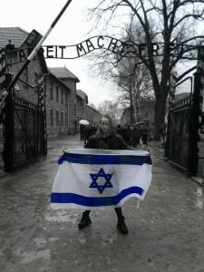 Miriam Ciss Outside Auschwitz Concentration Camp with Flag of Israel