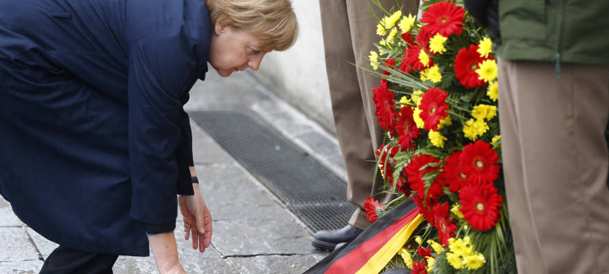 German Chancellor Angela Merkel lays a wreath at Dachau