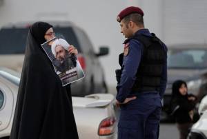A Bahraini protester holds up a picture of Saudi Shiite cleric Sheikh Nimr al-Nimr. (AP/Hasan Jamali)