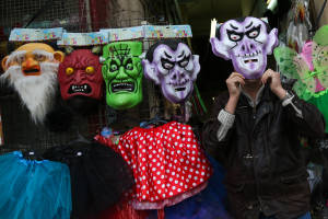 An Israeli man offers costumes before the upcoming Jewish holiday of Purim. (Nati Shohat/Flash 90)