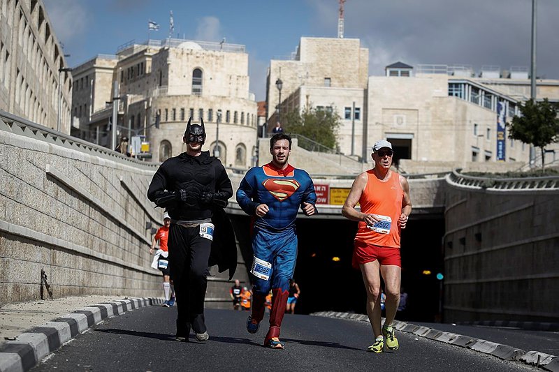 Superheroes show their powers in the Jerusalem marathon. (Nati Shohat/Flash90)