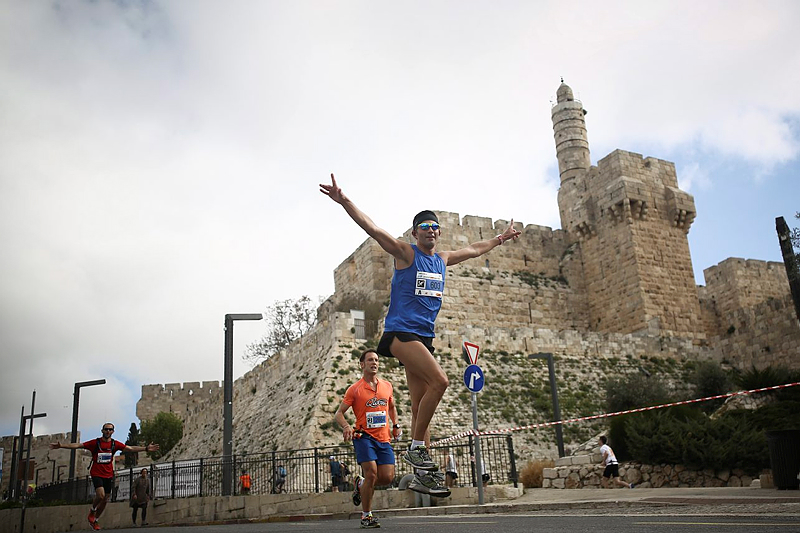 Runners pass Jerusalem's Old City walls.  (Yonatan Sindel/Flash90)