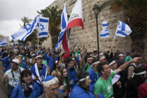 Jewish youth march near the walls of the old city in Jerusalem