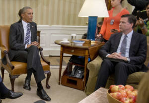 FBI Director James Comey, right, listens to President Barack Obama, left, speak to members of the media in the Oval Office of the White House in Washington, Monday, June 13, 2016, after receiving an update on the massacre at an Orlando nightclub. Comey says the gunman in the Orlando nightclub attack that killed 49 people had 